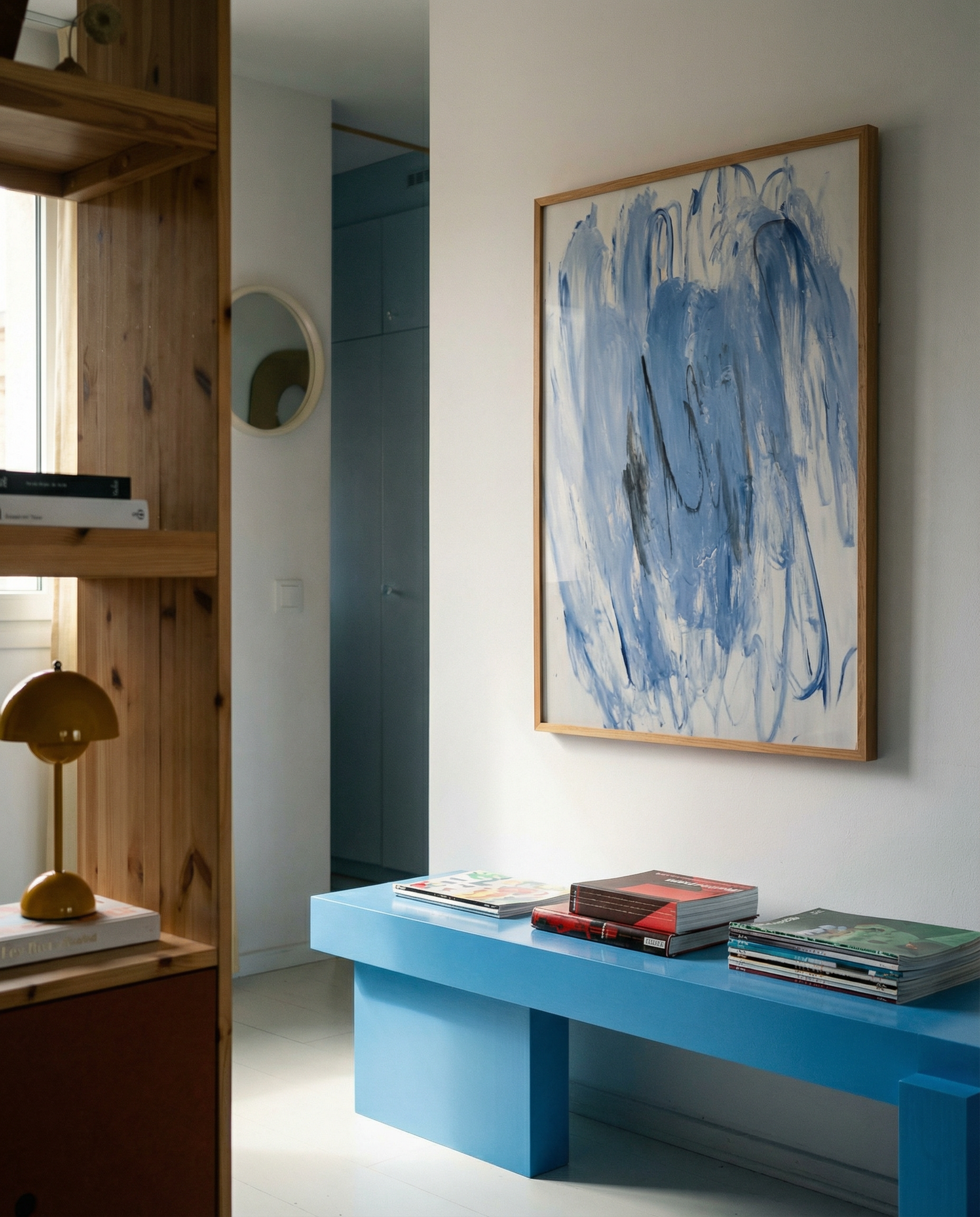 Modern interior with a blue bench, abstract painting, and wooden shelf. Veil – Contemporary Abstract Canvas | Oversized Luxury Wall Art | Brume Art | Luxury Wall Decor | Large Canvas Wall Art | Oversized Wall Hanging-Brume art