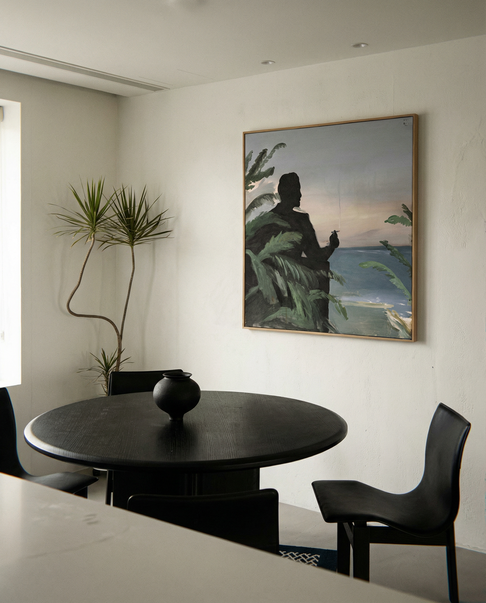 Modern dining room with a black round table and chairs, featuring a large framed painting on the wall. Tycoon – Figurative Canvas Wall Art | Premium Luxury Print | Brume Art| Luxury Wall Decor | Large Canvas Wall Art | Oversized Wall Hanging-Brume art