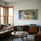 Living room with brown leather sofa, wooden coffee table, and abstract painting on wall. Depth – Bold Abstract Canvas Print | Large Luxury Wall Art | Brume Art