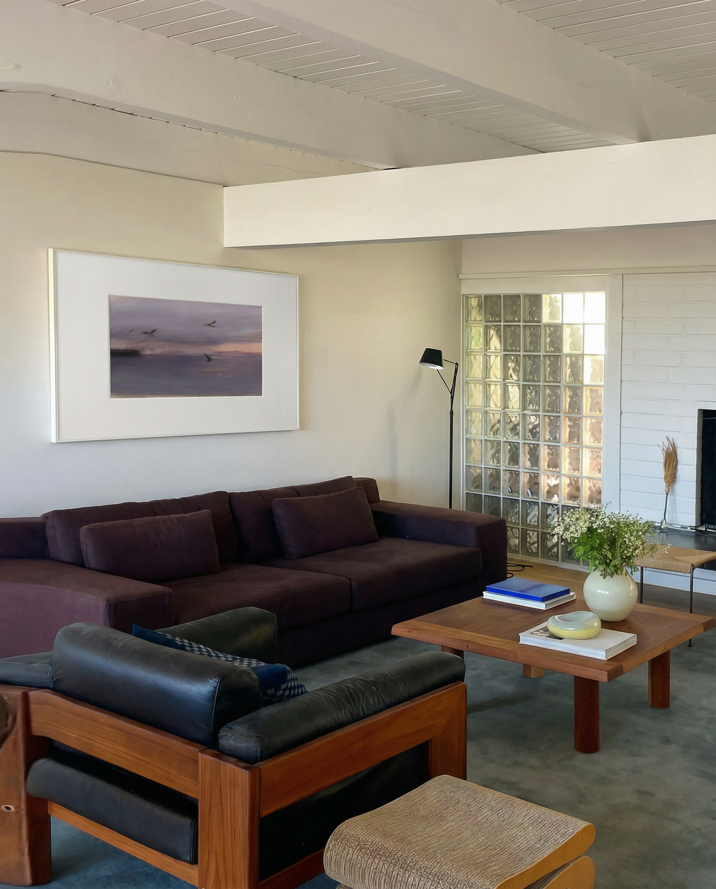 Living room with a brown sectional sofa, wooden coffee table, and framed artwork on the wall. Away – Minimalist Abstract Canvas Art | Large Luxury Wall Decor | Brume Art