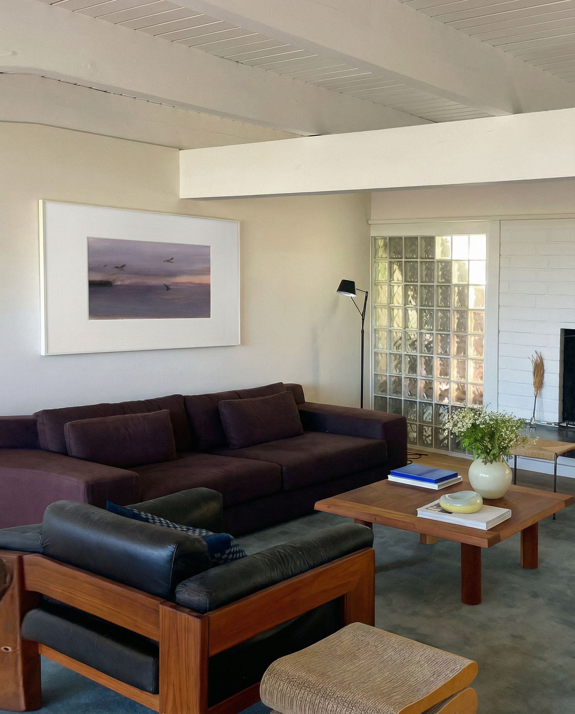 Living room with a brown sectional sofa, wooden coffee table, and framed artwork on the wall. Away – Minimalist Abstract Canvas Art | Large Luxury Wall Decor | Brume Art