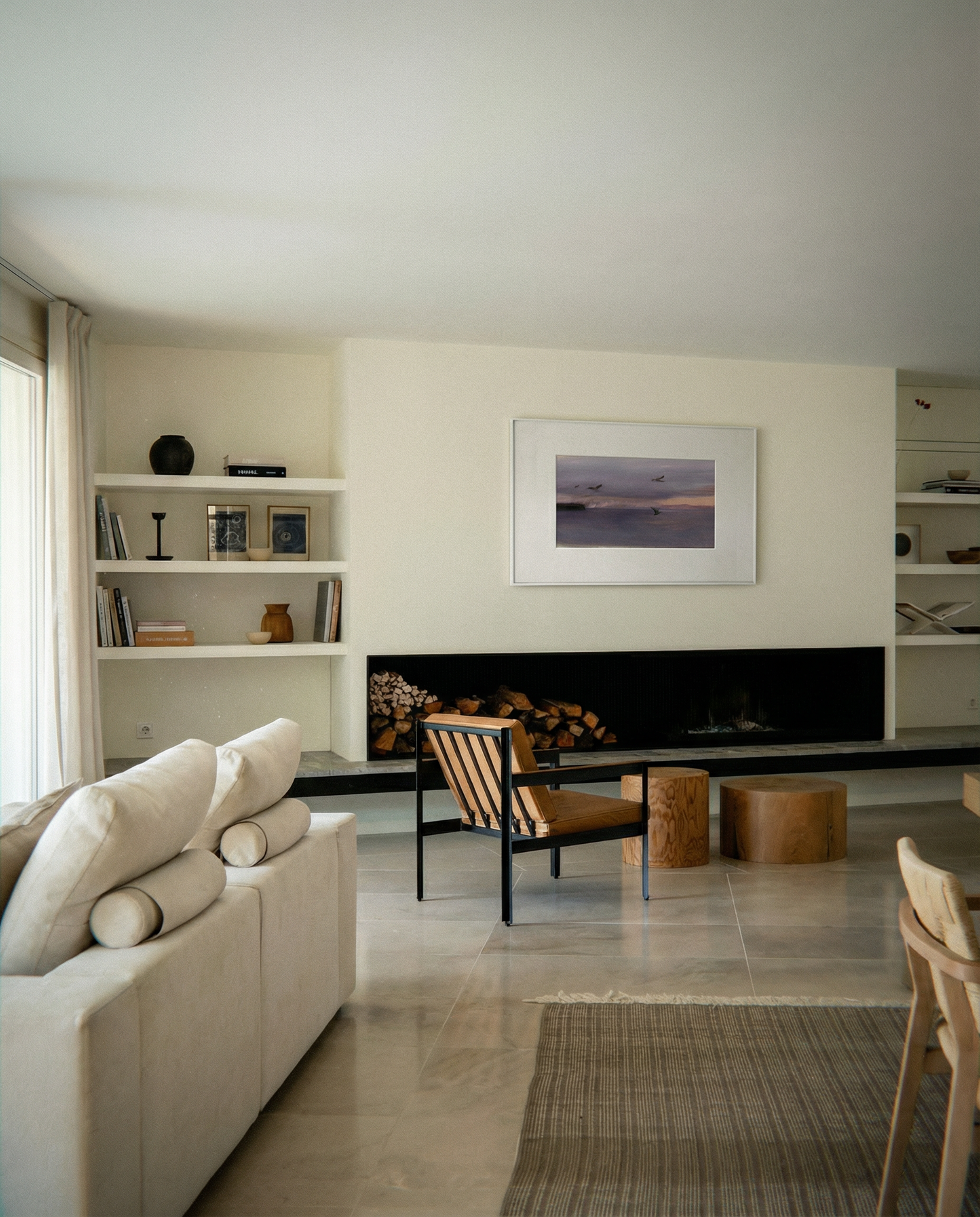 Modern living room with a fireplace, bookshelves, and a sofa. Away – Minimalist Abstract Canvas Art | Large Luxury Wall Decor | Brume Art