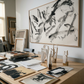 Artistic workspace with framed artwork and prints on a wooden desk. Ink 2 – Abstract Ink Canvas Wall Art | Oversized Luxury Print | Brume Art