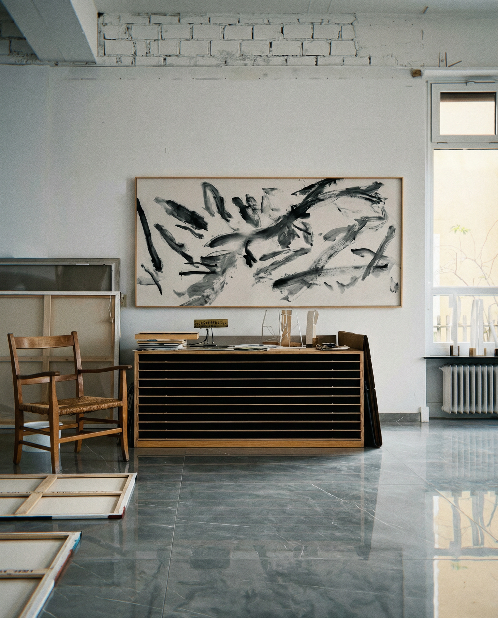 Modern interior with abstract painting on a white wall, wooden furniture, and large windows. Ink 2 – Abstract Ink Canvas Wall Art | Oversized Luxury Print | Brume Art