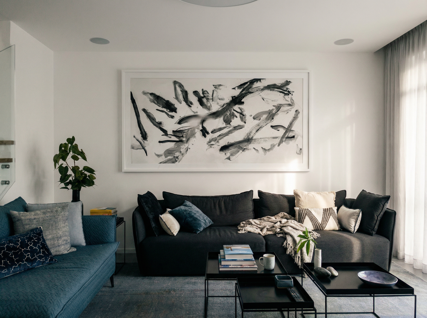 Modern living room with a gray sofa, blue accent chair, and abstract artwork on the wall. Ink 2 – Abstract Ink Canvas Wall Art | Oversized Luxury Print | Brume Art