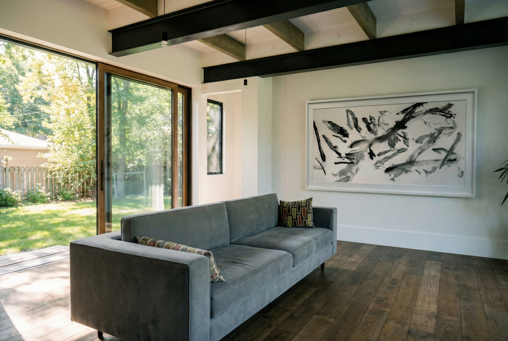 Modern living room with a gray sofa, abstract painting, and large windows. Ink 2 – Abstract Ink Canvas Wall Art | Oversized Luxury Print | Brume Art