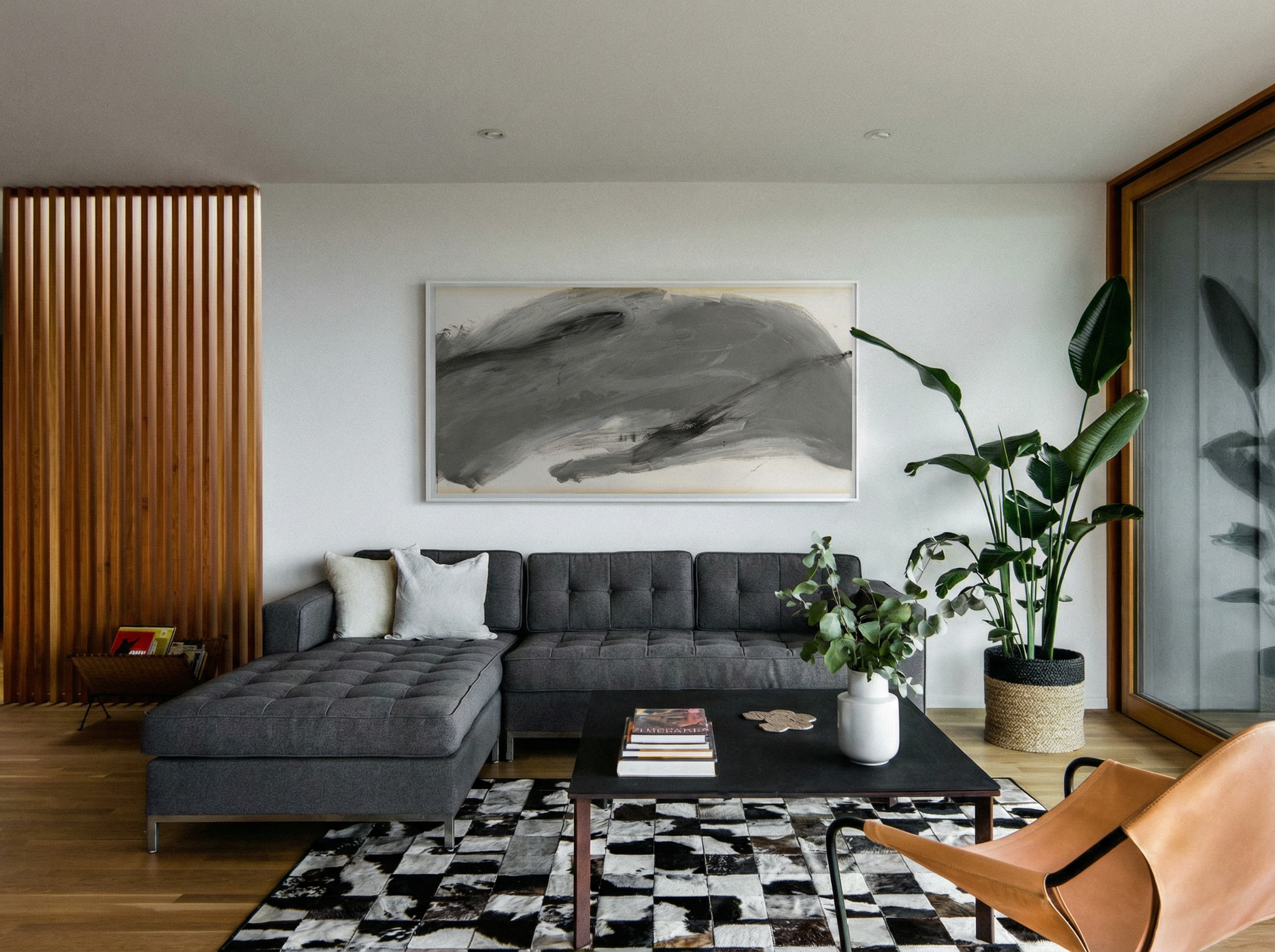 Modern living room with a gray sectional sofa, black coffee table, and abstract painting on the wall. Fade 3 – Minimalist Abstract Canvas Art | Large Luxury Wall Print | Brume Art | Luxury Wall Decor | Large Canvas Wall Art | Oversized Wall Hanging-Brume art