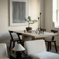 Modern dining room with a table, chairs, and decorative items. fade 2 – Minimalist Abstract Canvas Art | Large Luxury Wall Print | Brume Art | Luxury Wall Decor | Large Canvas Wall Art | Oversized Wall Hanging-Brume art