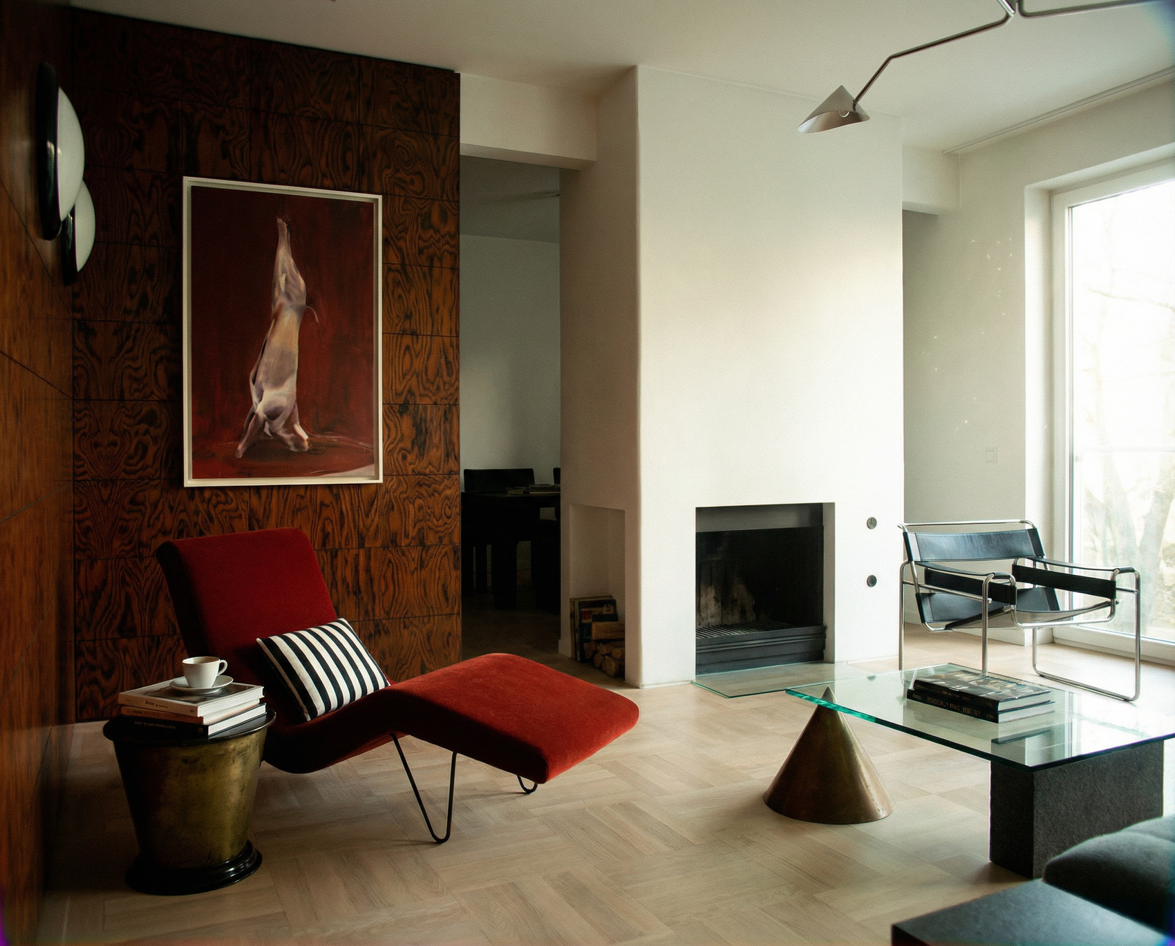 Modern living room with a red chair, ottoman, and artwork on a textured wall. Painting of a dog standing on its hind legs against a red background Suspension – Nature Canvas Wall Art | Large Luxury Print | Brume Art