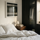 Neatly made bed in a bedroom with a dark wardrobe and framed abstract art on the wall. Horizon 2 – Bold Abstract Canvas Wall Art | Premium Luxury Print | Brume Art