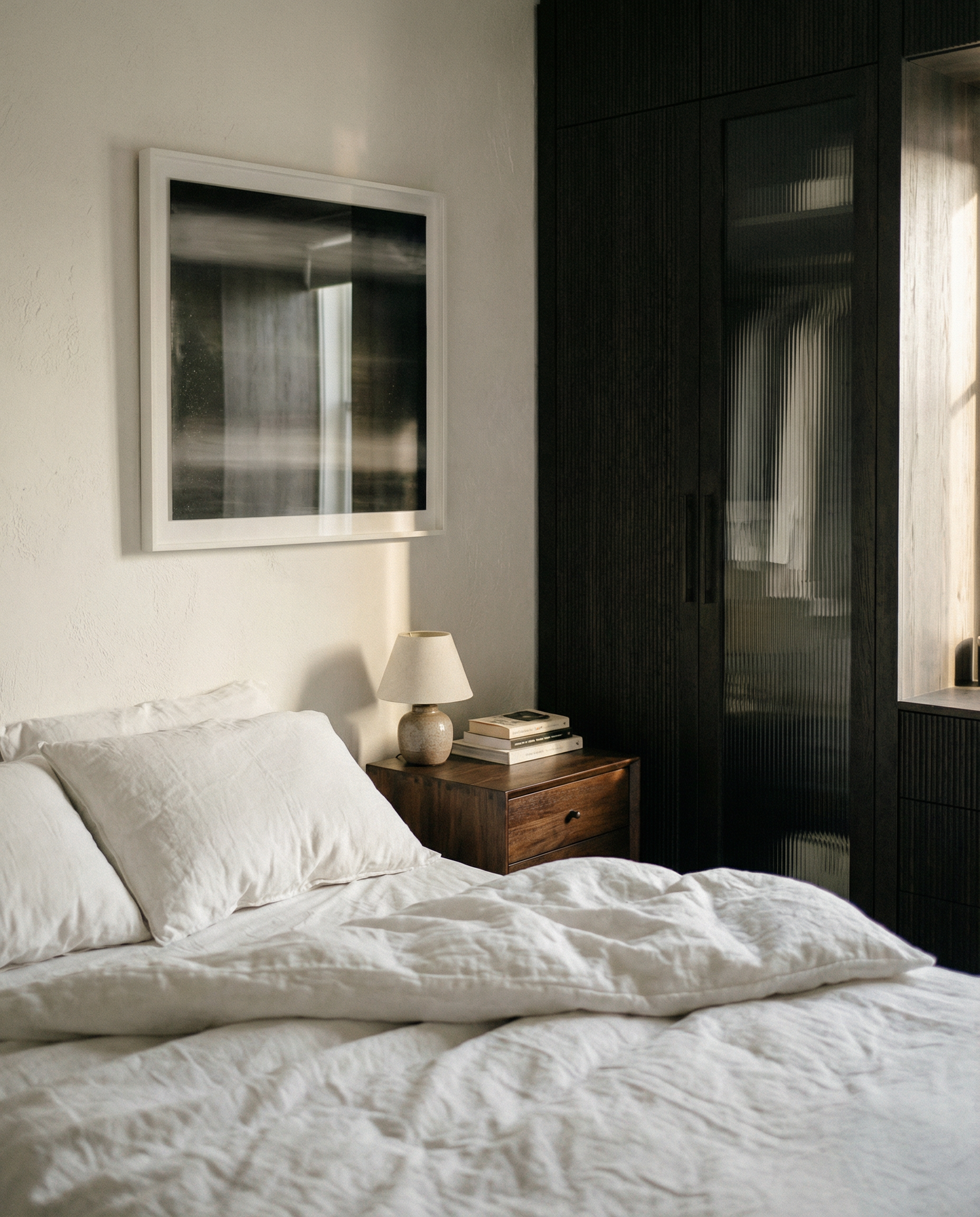 Neatly made bed in a bedroom with a dark wardrobe and framed abstract art on the wall. Horizon 2 – Bold Abstract Canvas Wall Art | Premium Luxury Print | Brume Art