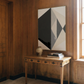 Wooden table with a vase and books against a wall with geometric art Rhombus – Minimalist Abstract Canvas Art | Large Luxury Wall Decor | Brume Art| Luxury Wall Decor | Large Canvas Wall Art | Oversized Wall Hanging-Brume art