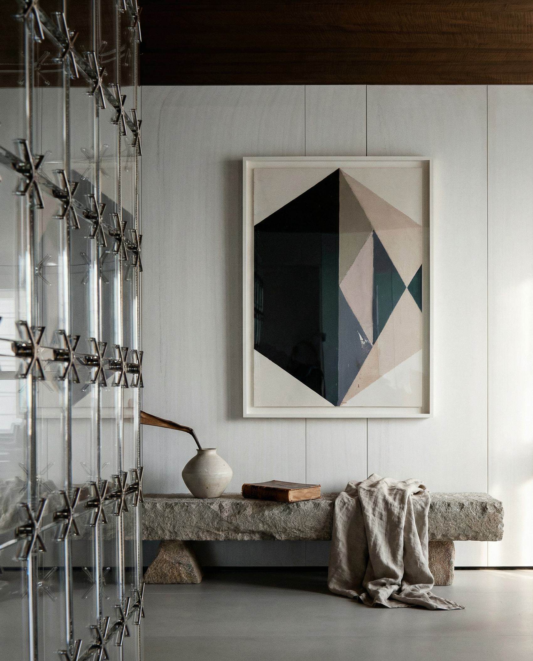 Modern interior with a geometric art piece on the wall, a stone bench, and decorative elements. Rhombus – Minimalist Abstract Canvas Art | Large Luxury Wall Decor | Brume Art| Luxury Wall Decor | Large Canvas Wall Art | Oversized Wall Hanging-Brume art
