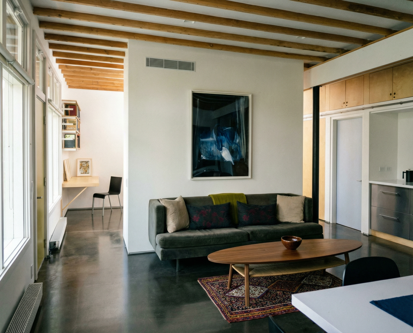 Modern living room with a gray sofa, wooden coffee table, and abstract painting on the wall. Field black – Landscape Canvas Wall Art | Large Luxury Print | Brume Art