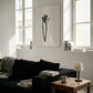 Modern living room with a black sofa, wooden coffee table, and framed artwork. Blossom – Botanical Canvas Wall Art | Large Luxury Print | Brume Art