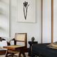 Modern living room with wooden chair, black sofa, and abstract artwork on the wall. Blossom – Botanical Canvas Wall Art | Large Luxury Print | Brume Art