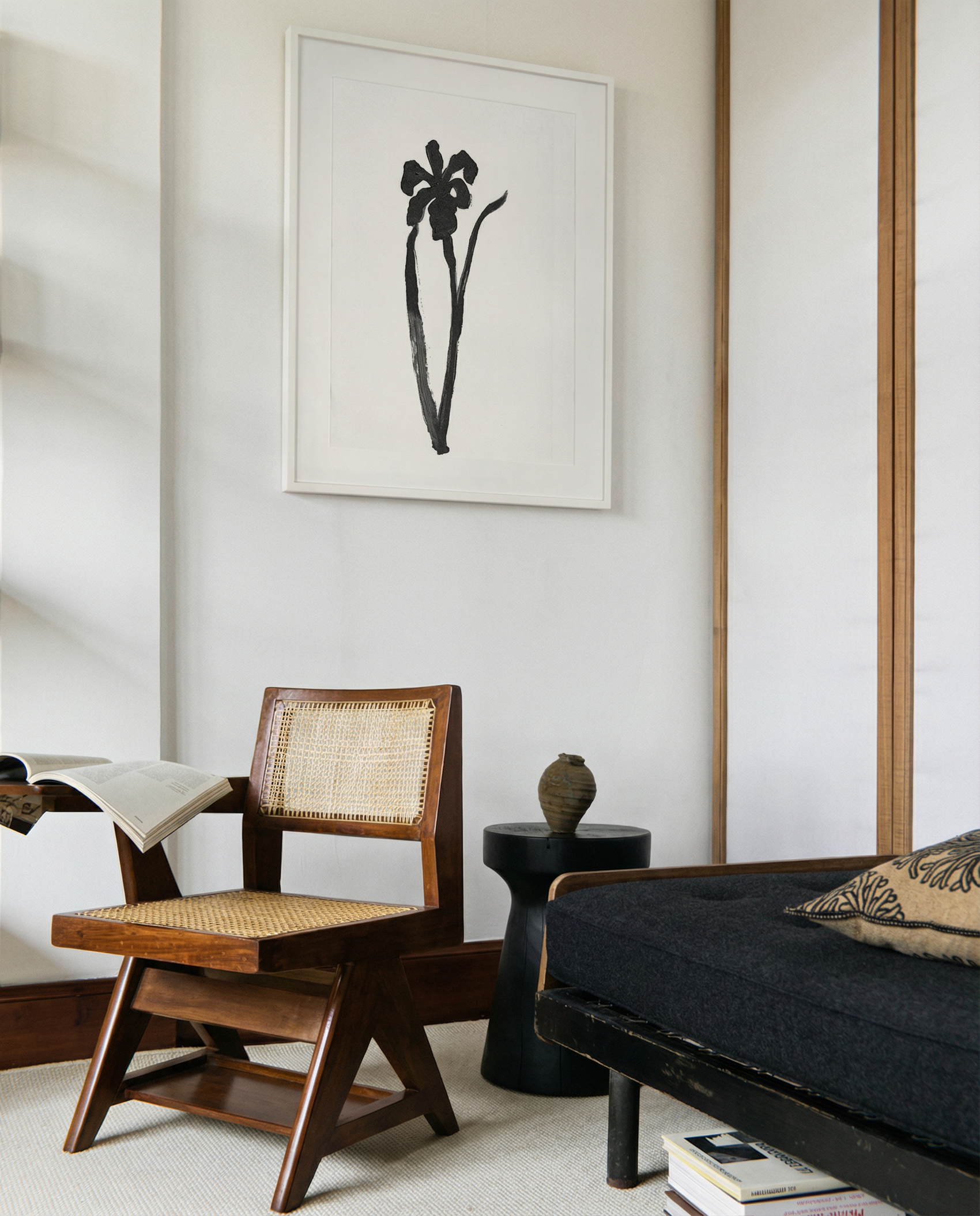 Modern living room with wooden chair, black sofa, and abstract artwork on the wall. Blossom – Botanical Canvas Wall Art | Large Luxury Print | Brume Art