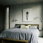 Modern bedroom with gray bedding, wooden headboard, and wall art. Blossom – Botanical Canvas Wall Art | Large Luxury Print | Brume Art