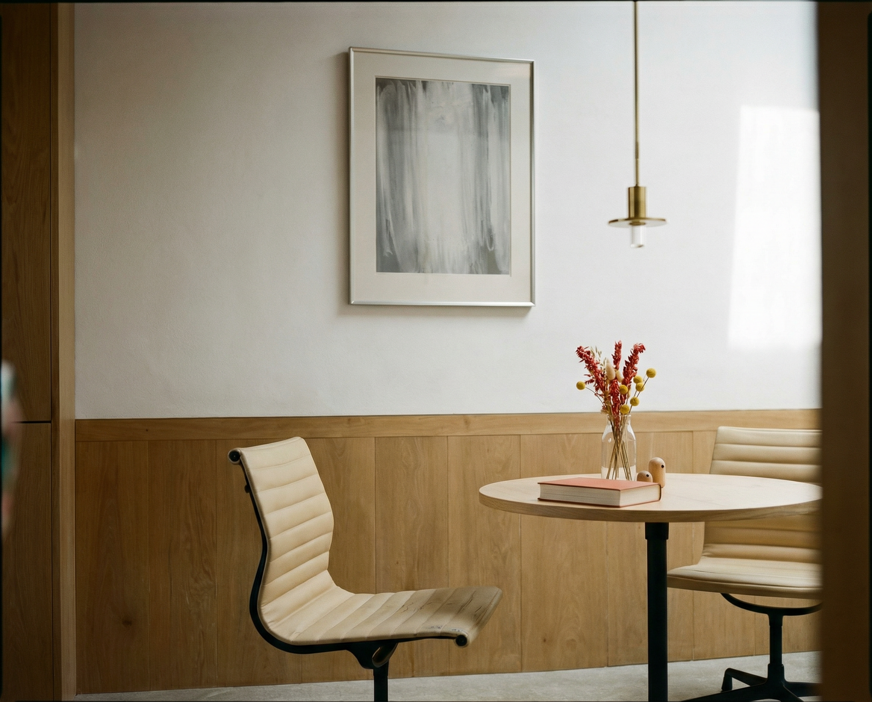 Modern interior with a round table, chairs, and a framed picture on the wall. fade 4– Bold Abstract Canvas Print | Large Luxury Wall Art | Brume Art| Luxury Wall Decor | Large Canvas Wall Art | Oversized Wall Hanging-Brume art