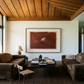 Modern living room with brown sofas, a coffee table, and a large abstract painting on the wall. silent run – Contemporary Animal Canvas Art | Luxury Wall Decor | Brume Art