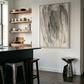 Modern kitchen with black island, wooden shelves, and abstract art on the wall. Veil 2 – Bold Abstract Canvas Print | Large Luxury Wall Art | Brume Art| Luxury Wall Decor | Large Canvas Wall Art | Oversized Wall Hanging-Brume art