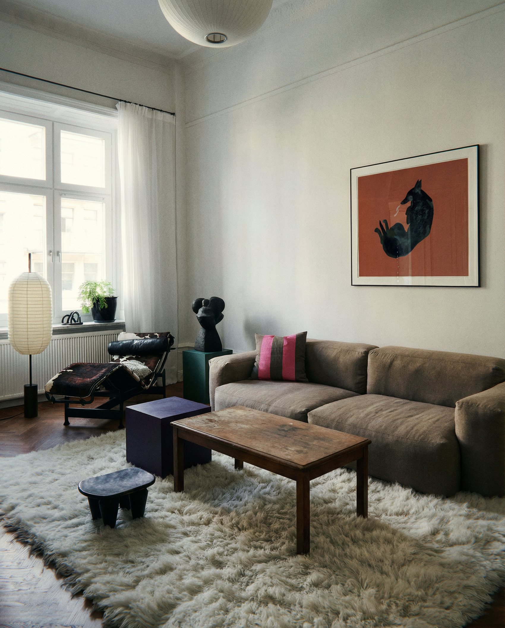 Modern living room with a brown sectional sofa, wooden coffee table, and decorative items. Black dog – Contemporary Animal Canvas Art | Luxury Wall Decor | Brume Art | Luxury Wall Decor | Large Canvas Wall Art | Oversized Wall Hanging-Brume art