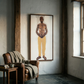 Room interior with a leather armchair, small table, and large framed artwork on the wall. Fisherman of manila-Figurative Canvas Wall Art | Premium Luxury Print | Brume Art | Luxury Wall Decor | Large Canvas Wall Art | Oversized Wall Hanging-Brume art