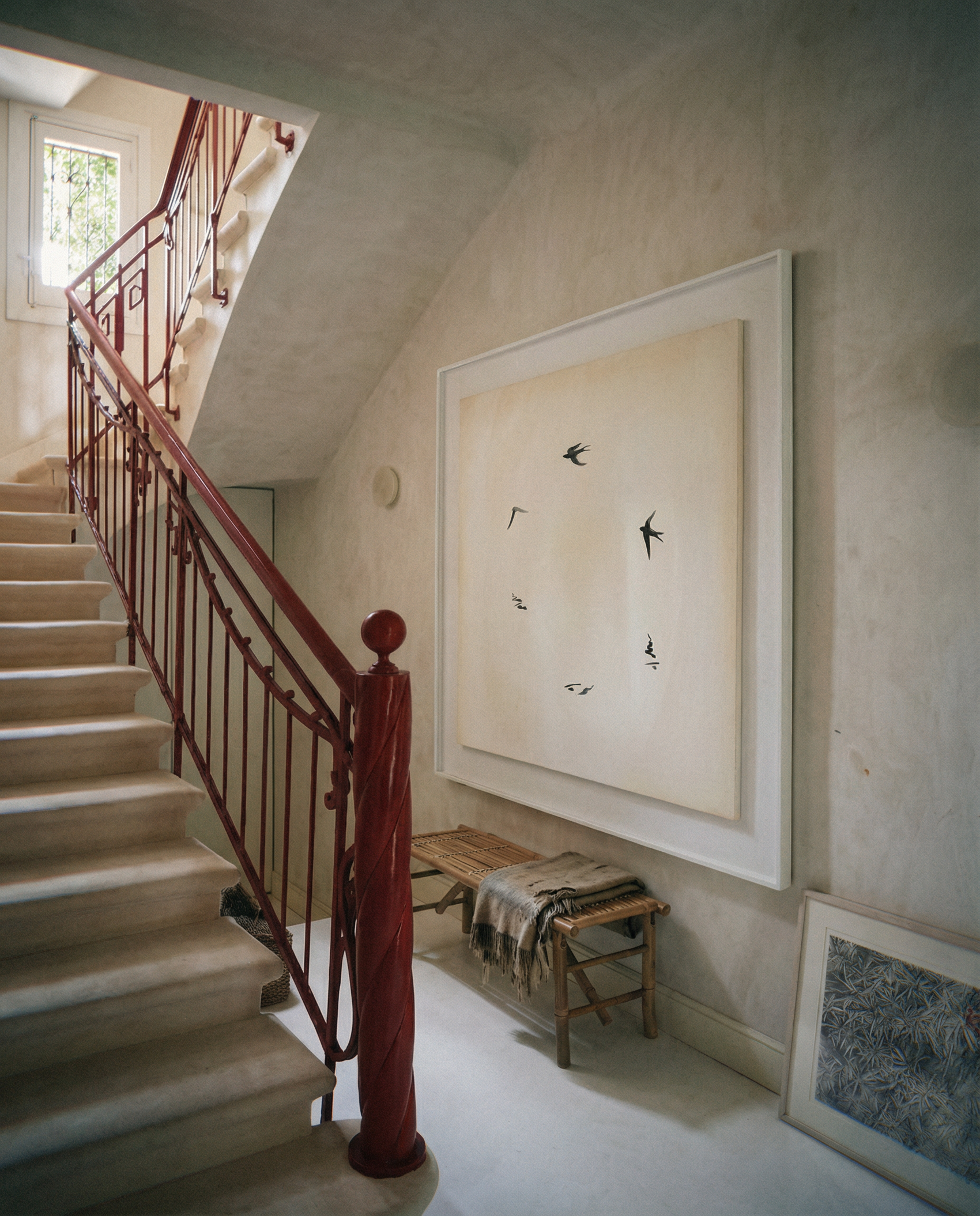 Staircase with red railing and wall art in a home interior.  Birds – Nature Canvas Wall Art | Large Luxury Print | Brume Art