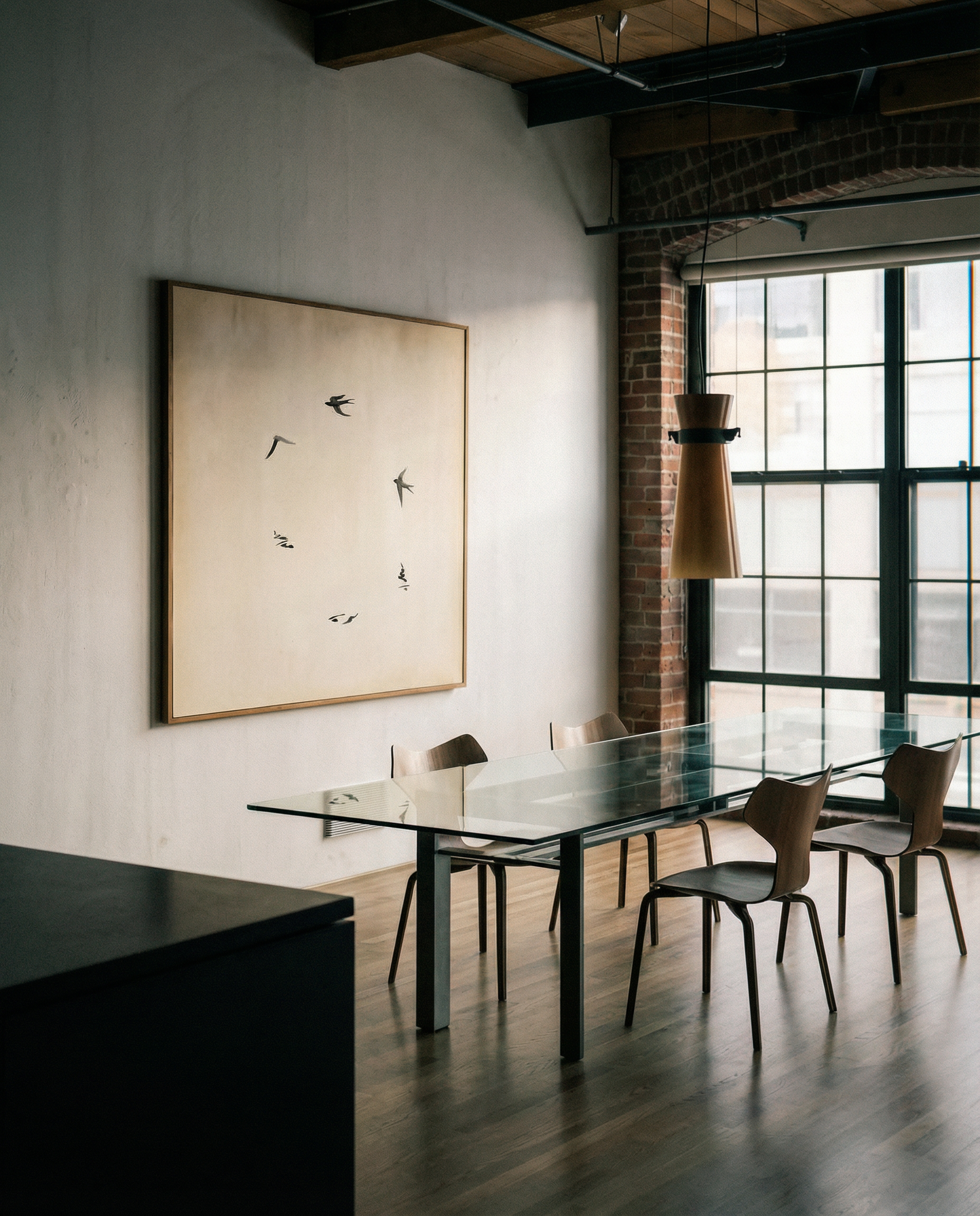 Modern dining room with a large abstract painting on the wall and a glass dining table.  Birds – Nature Canvas Wall Art | Large Luxury Print | Brume Art