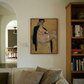 Living room with a painting on the wall, a couch, and a bookshelf. Girl with Short Hair – Portrait Canvas Art | Luxury Wall Decor | Brume Art