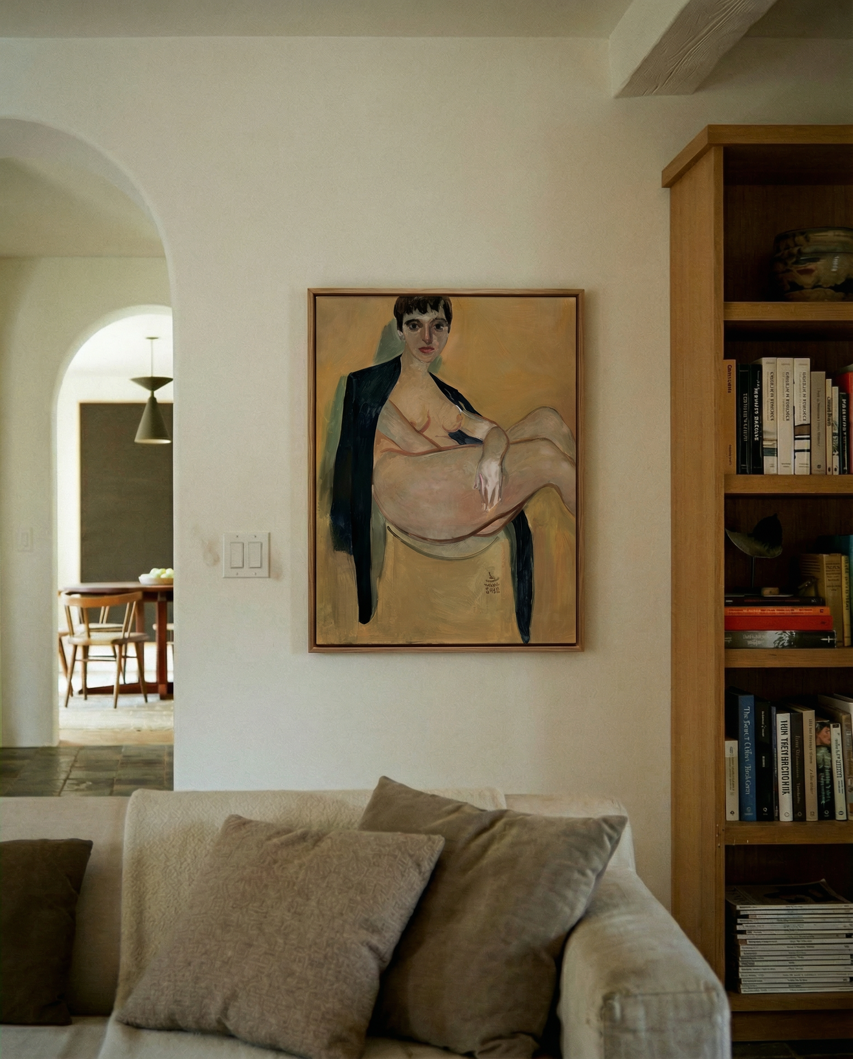 Living room with a painting on the wall, a couch, and a bookshelf. Girl with Short Hair – Portrait Canvas Art | Luxury Wall Decor | Brume Art