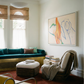 Modern living room with teal sofa, white ottoman, and abstract art on the wall. Figure and Flame – Figurative Canvas Wall Art | Premium Luxury Print | Brume Art