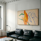 Living room with black leather sofa, abstract painting on wall, and coffee table. Figure and Flame – Figurative Canvas Wall Art | Premium Luxury Print | Brume Art