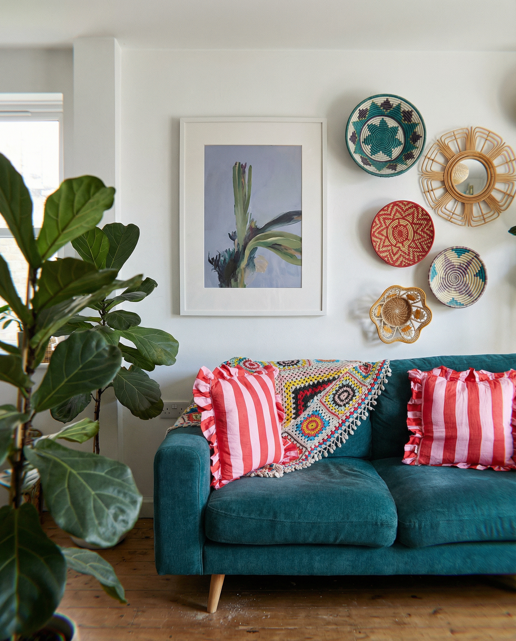 Living room with teal sofa, colorful pillows, and decorative plates on the wall. Orchid – Botanical Canvas Wall Art | Large Luxury Print | Brume Art