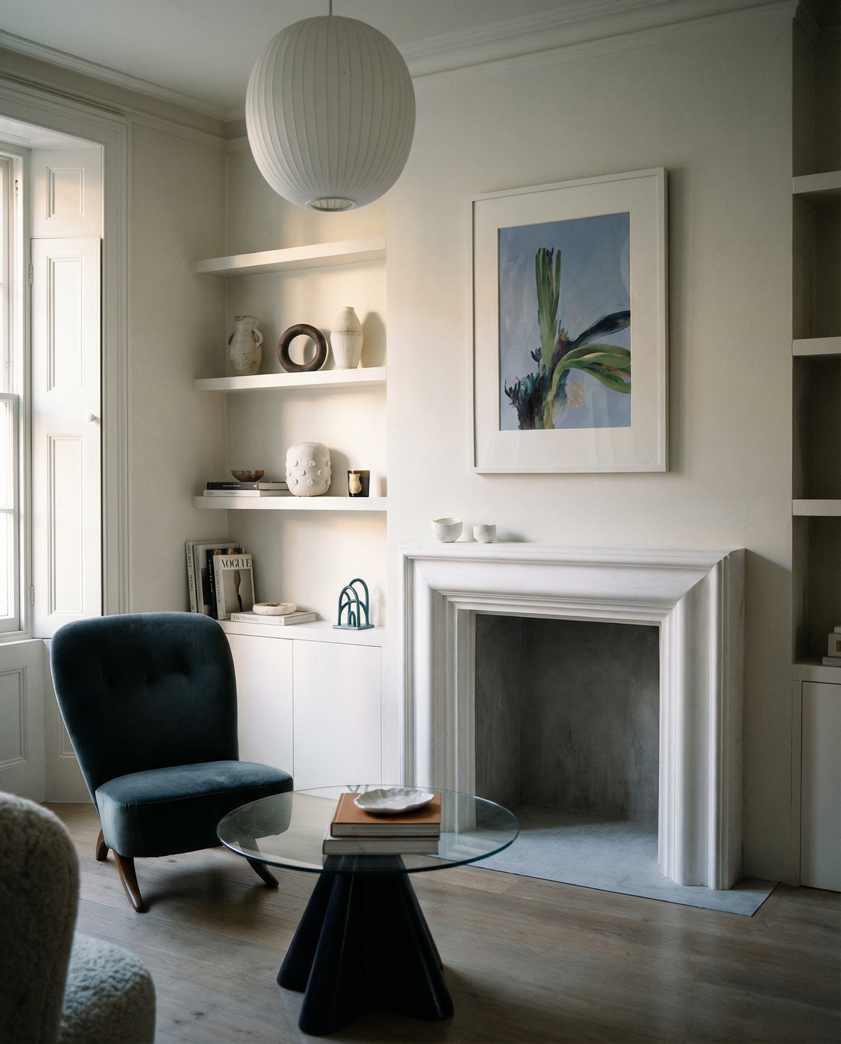 Modern living room with a fireplace, shelves, and a chair. Orchid – Botanical Canvas Wall Art | Large Luxury Print | Brume Art