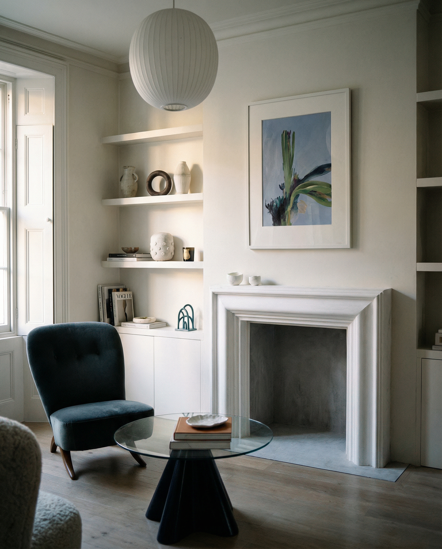 Modern living room with a fireplace, shelves, and a chair. Orchid – Botanical Canvas Wall Art | Large Luxury Print | Brume Art