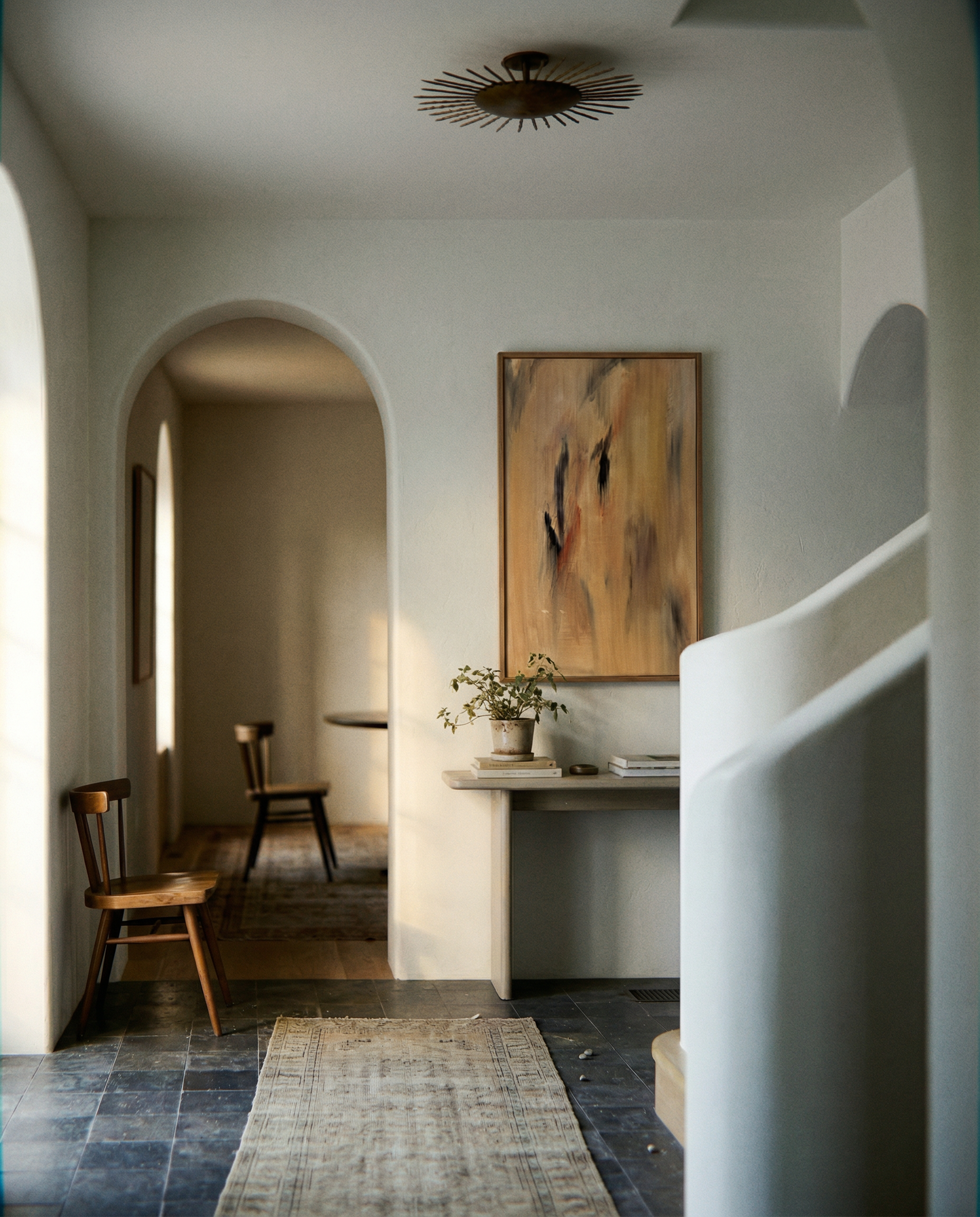 Modern interior with abstract painting on a wall, wooden chairs, and a rug. Abstract painting with brown and black brush strokes on a beige background Field Yellow 2 – Landscape Canvas Wall Art | Premium Luxury Print | Brume Art