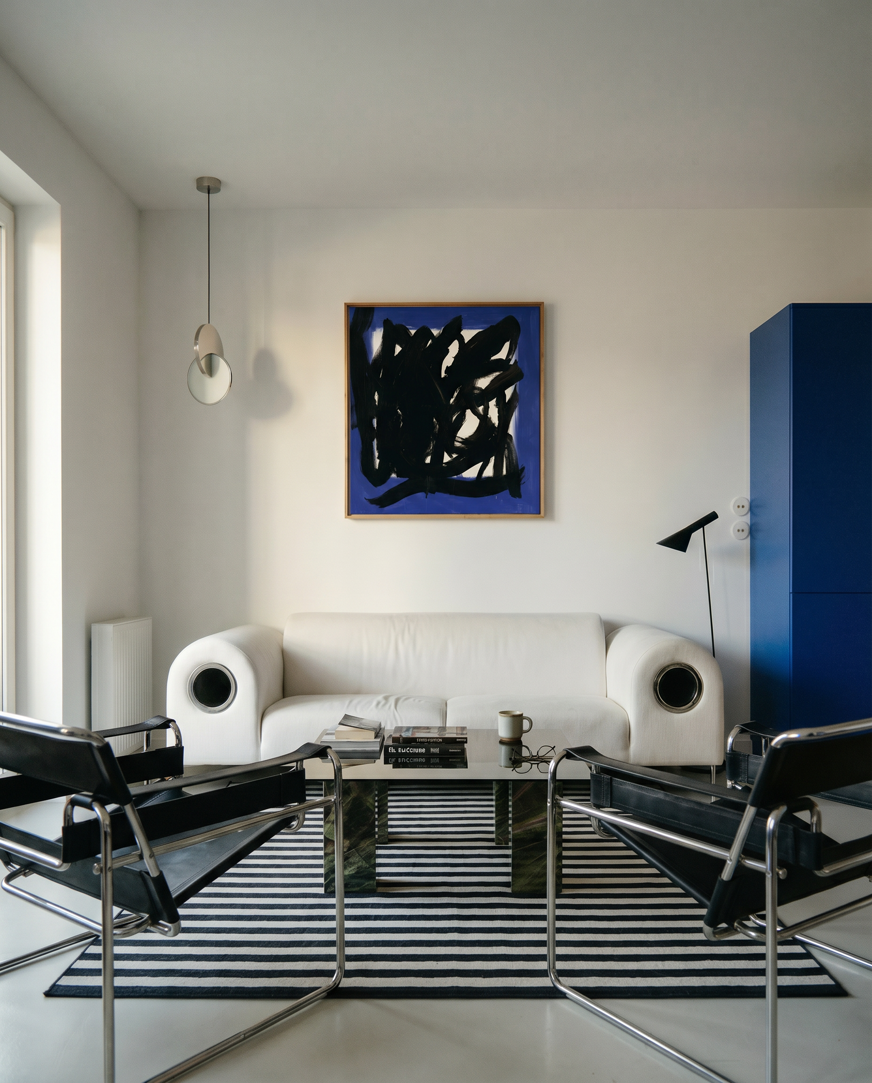 Modern living room with white sofa, abstract art, and striped rug. Noise 5 – Bold Abstract Canvas Print | Large Luxury Wall Art | Brume Art