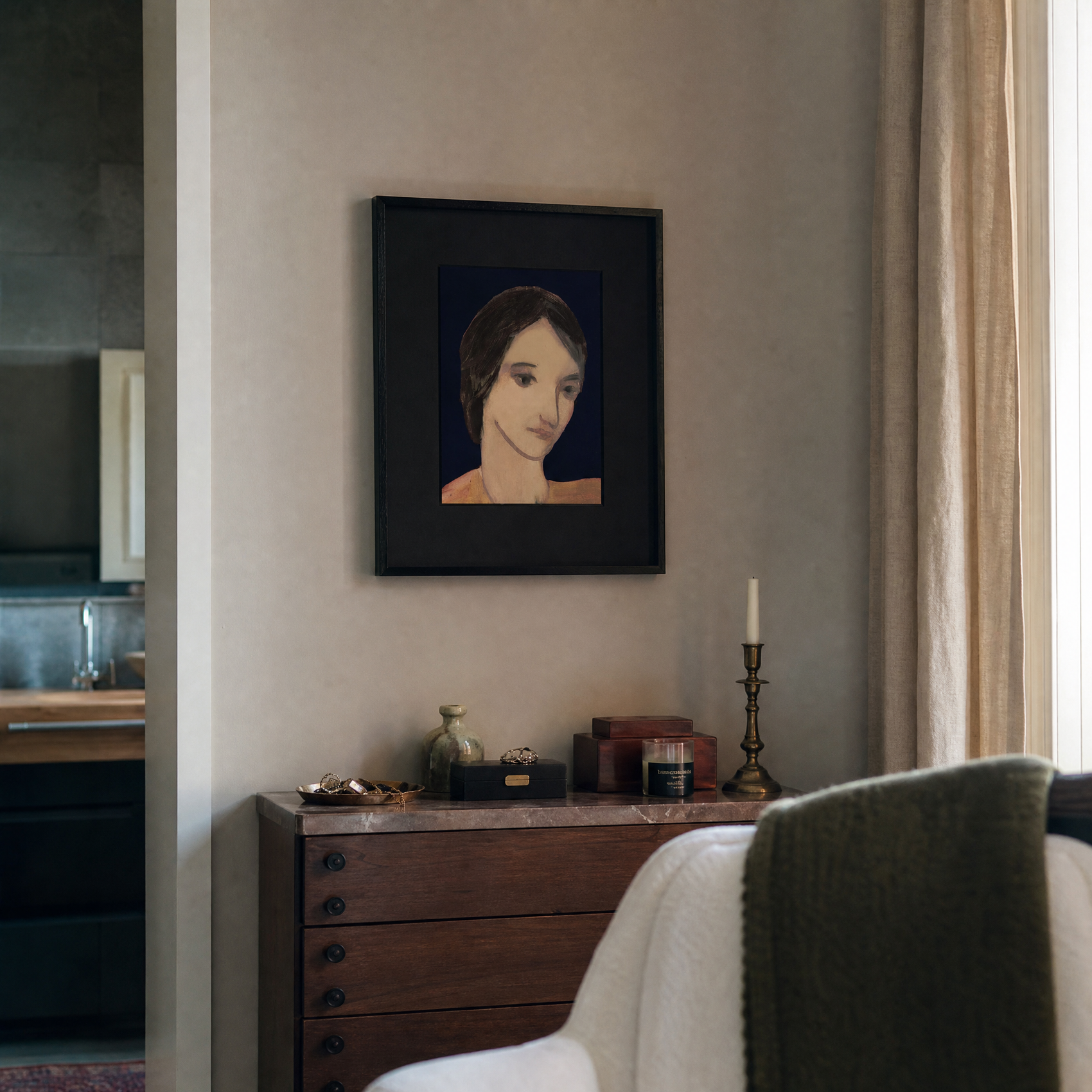 Framed portrait on a wall above a wooden dresser with decorative items.