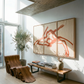 Modern living room with abstract art, wooden bench, and plant
