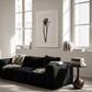 Modern living room with a black sofa, wooden coffee table, and framed artwork. Blossom – Botanical Canvas Wall Art | Large Luxury Print | Brume Art