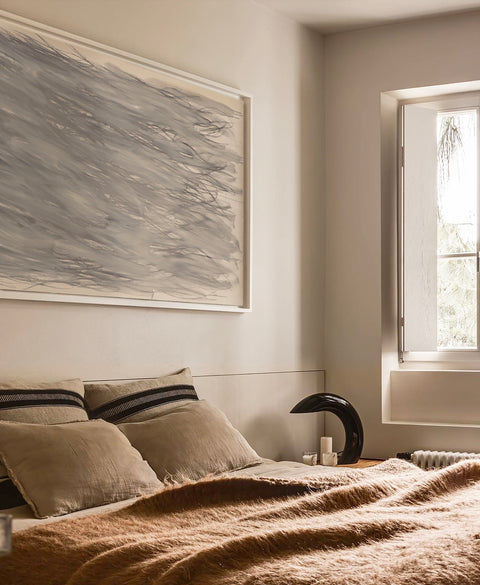 a large abstract canvas art hanging on the bed room's wall