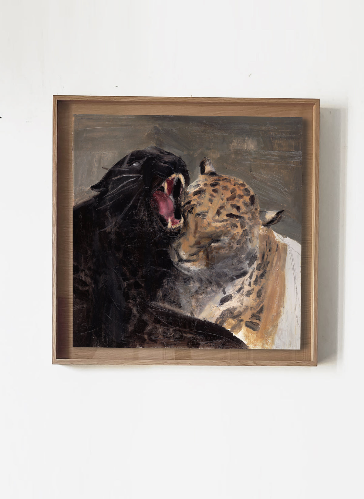 A framed painting depicting a black panther roaring next to a leopard with a white cloth draped over its shoulder, hung on a plain white wall.