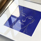 Framed artwork of a face on a blue background Presence 4 – Figurative Abstract Canvas Print | Large Luxury Wall Art | Brume Art