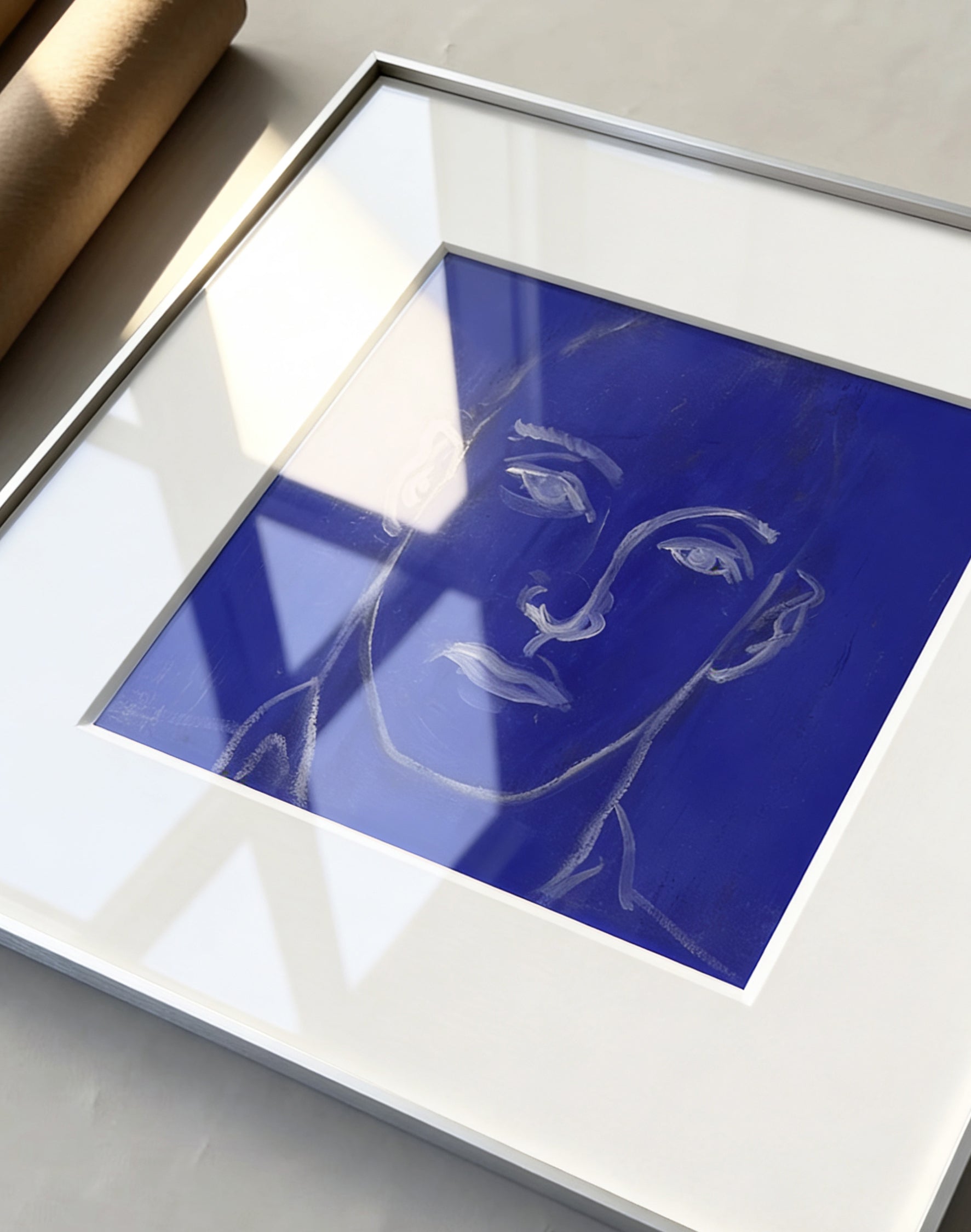 Framed artwork of a face on a blue background Presence 4 – Figurative Abstract Canvas Print | Large Luxury Wall Art | Brume Art