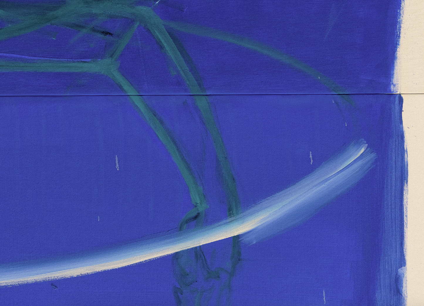 Close-up of a blue surface with green fibers and a white line.