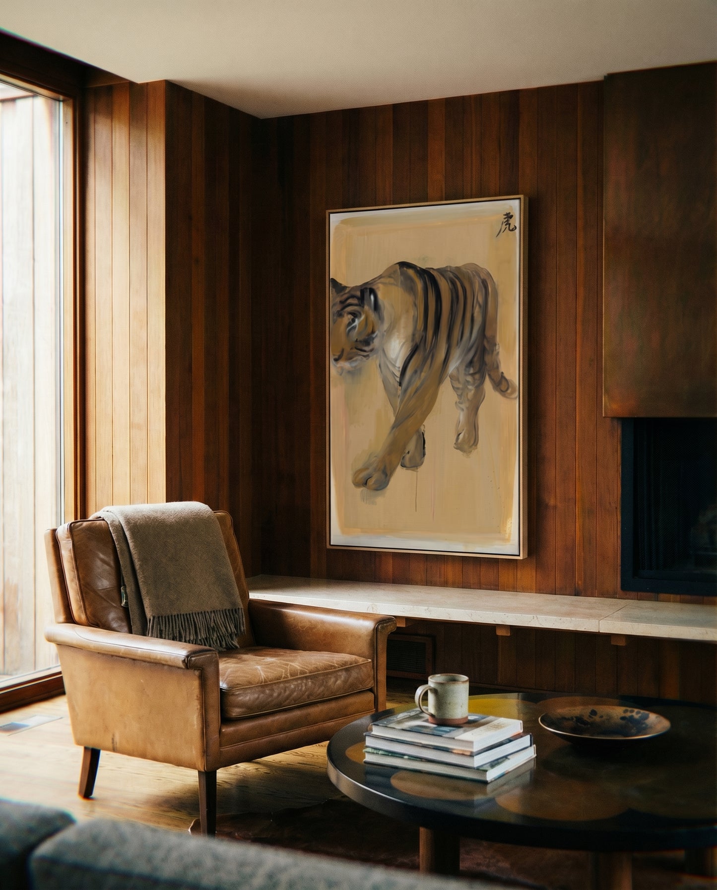 Living room with a brown leather armchair, coffee table, and tiger painting on wooden wall. Tiger – Contemporary Animal Canvas Art | Luxury Wall Decor | Brume Art