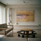 Modern living room with a neutral color palette, featuring a sofa, coffee table, and abstract painting on the wall. Field Yellow – Landscape Canvas Wall Art | Large Luxury Print | Brume Art