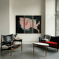 Modern living room with a black leather chair, gray sofa, and abstract artwork on the wall. Embrace – Figurative Canvas Wall Art | Oversized Luxury Print | Brume Art