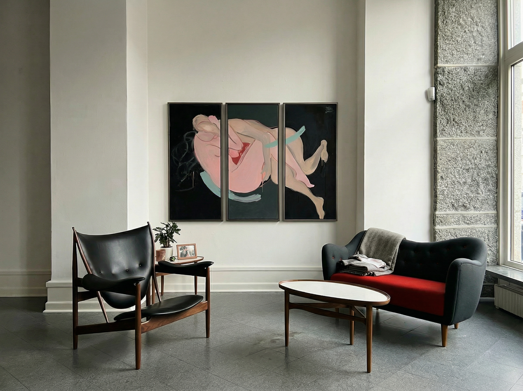 Modern living room with a black leather chair, gray sofa, and abstract artwork on the wall. Embrace – Figurative Canvas Wall Art | Oversized Luxury Print | Brume Art